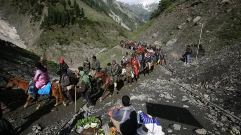 Getty Images Indian Hindu pilgrims cross mountain trails during their religious journey to the Amarnath cave