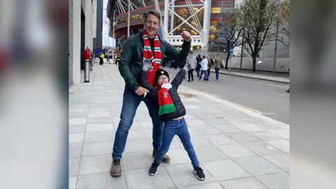 Sophie Delaney Joey and his dad outside the stadium