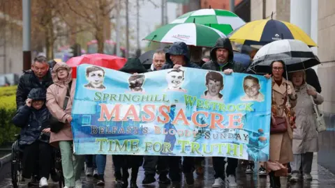 PA Media Relatives of those was killed during the Springhill killings, outside the coroners court at Laganside in Belfast on Monday