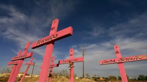 Getty Images Wooden crosses are seen in the place where the corpses of eight murdered women were found in 2001 in Ciudad Juarez, Chihuahua, 11 April 2006.