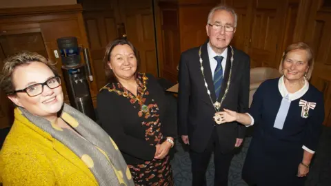 dcsdc The Mayor of Derry City and Strabane District Council, Cllr Michaela Boyle pictured with the new High Sheriff of Derry City, Richard Doherty at his installation at the Mayor’s Parlour, Guildhall this afternoon. Also included from left is Julia Keys, Outgoing High Sheriff, and on right, Dr. Angela Garvey, Lord Lieutenant of the County Borough of Londonderry
