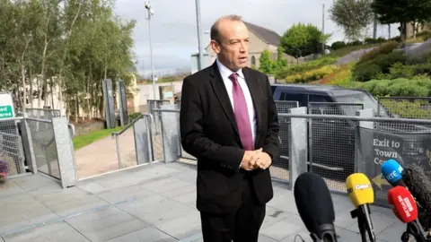 PA/Peter Morrison New secretary of state Chris Heaton-Harris speaks to the press in Dungannon