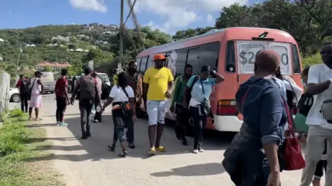 BBC West African visitors - predominantly from Cameroon - shortly after arriving by charter flight on Christmas Eve trying to find accommodation in Antigua, December 2022