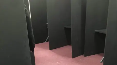 A pupil sitting in an isolation booth