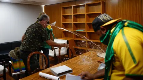 Reuters Vandals inside a room in the presidential palace