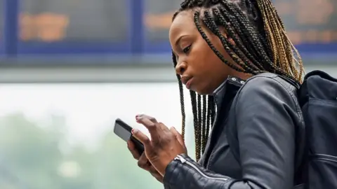 Getty Images Woman using a mobile phone