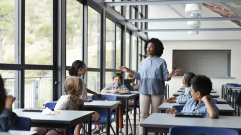 Getty Images Teacher teaching a small class of children