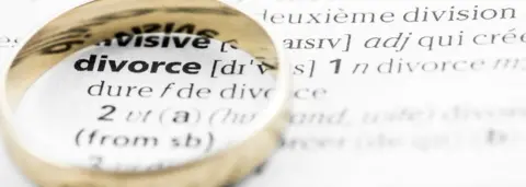 Getty Images Divorce dictionary definition below a wedding ring