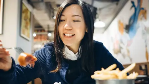 Woman eating at a restaurant