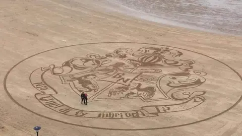 Nia Roderick Nia and Ben with Mark Treanor's artwork