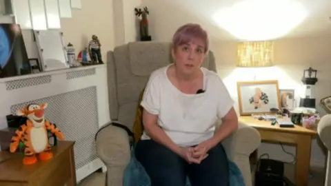 Tammy Wood sitting in her living room