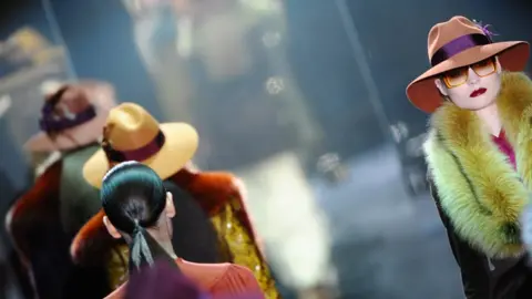 Getty Images A model on the catwalk wearing a Gucci fur coat