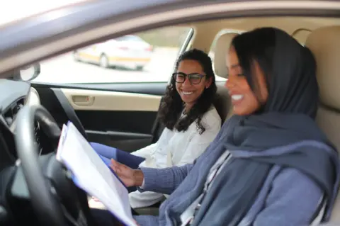 Reuters Student Maria al-Faraj with driving instructor Ahlam al-Somali