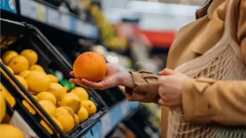 Getty Images Woman food shopping - stock shot