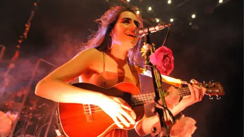Getty Images Dodie playing on stage