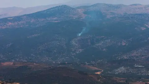 Reuters Smoke rises in Kfar Shouba, as seen from the village of Khiam, southern Lebanon, near the border with Israel (6 July 2023)