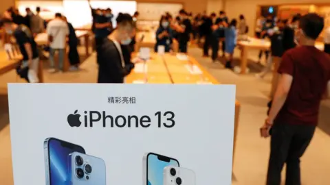 Reuters An iPhone 13 sign with Chinese lettering on display at a store in Beijing