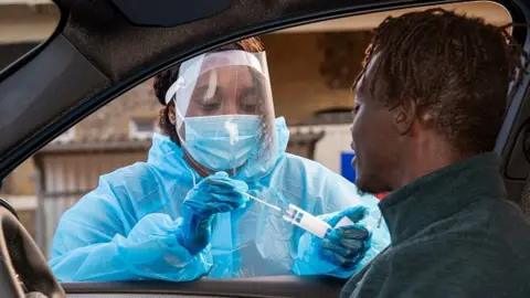 Getty Images Person getting a Covid test at a drive-through centre