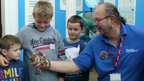 Nigel Brown, Clacton Pier Doz Ansell with children at the Seaquarium at Clacton Pier