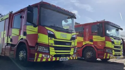 A front-on shot of two fire lorries parked next to one another.