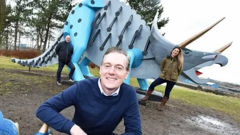 Middlesbrough Council Former Middlesbrough mayor Andy Preston and councillors in front of a steel dinosaur