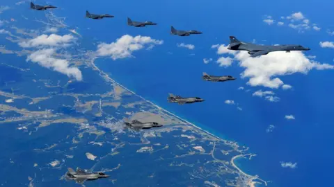 AFP/Getty A US Air Force B-1B Lancer bomber (R), US F-35B stealth jet fighters (bottom) and South Korean F-15K fighter jets (top) flying over South Korea during a joint military drill