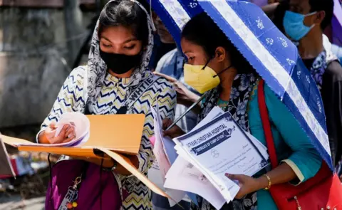 Getty Images job applicants in queue to submit forms at Mahendra Mohan Choudhury Hospital (MMCH), during the ongoing COVID-19 lockdown, in Guwahati.