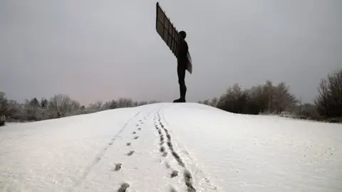 Owen Humphreys/PA Angel of the North with footprints in the snow