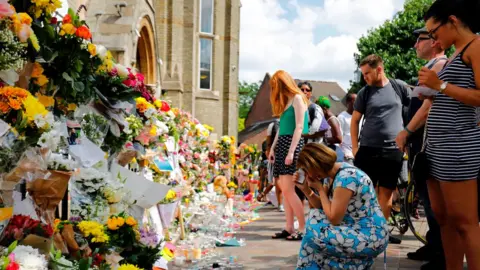 Getty/AFP Mourners pay tribute at Notting Hill Methodist Church
