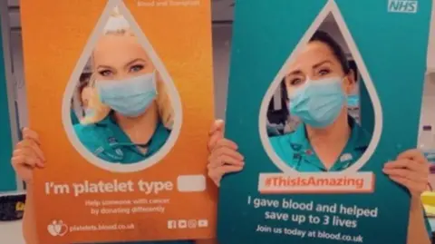 Anna Edwards Somer Elliott holding a sign about platelet donating and her mother Anna Edwards is holding one saying 'This is amazing, I gave blood and helped save three lives'.