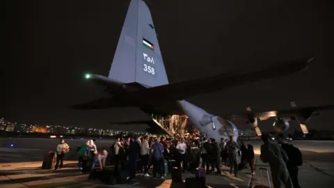 EPA People from a group of 343 citizens of Jordan, Palestine, Iraq, Syria, and Germany who were evacuated from Sudan disembark from military aircraft at Marka Military Airport, in Amman, Jordan, 24 April 2023.