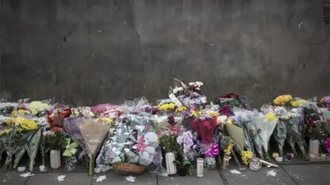 Getty Images Flowers at the scene of a shooting in Tottenham