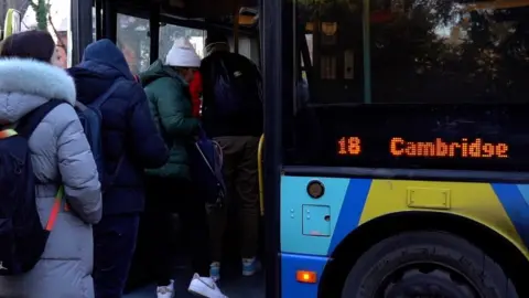 Passengers boarding a number 18 bus