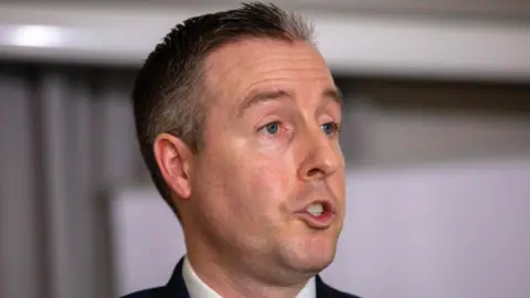 Getty Images Paul Givan speaking. 