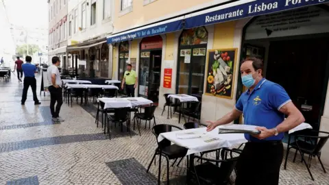 Reuters A waiter waits for customers at a restaurant, amid the coronavirus disease (COVID-19) outbreak, in downtown Lisbon, Portugal May 25