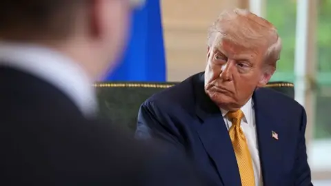 Getty Images Donald Trump, wears a suit, at a meeting with Ursula von der Leyen from the European Union at Turnberry Golf Club in Scotland