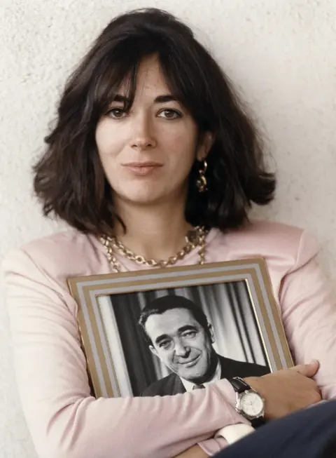 Getty Images Ghislaine Maxwell, holding a framed photograph of her late father in Jerusalem, 1991