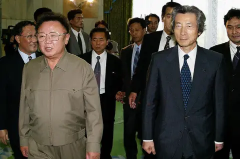 AFP via Getty Images Japanese Prime Minister Junichiro Koizumi walks with North Korean leader Kim Jong-Il before their talks in Pyongyang on 17 September 2002.