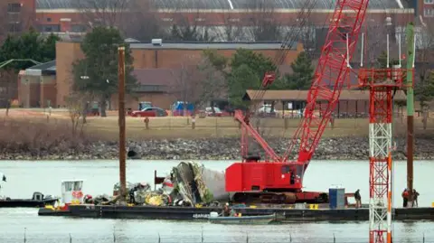 Getty Images A crane pulls wreckage of the American Airlines plane out of the Potomac River