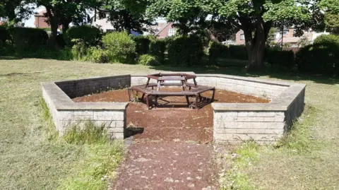 LDRS Fulwell War Memorial, a hexagonal wall with a bench at its centre
