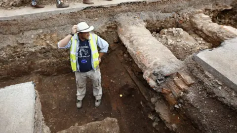 Reuters Archaeologist Mathew Morris stands in the trench where he found skeleton remains during an archaeological dig to find the remains of King Richard III in Leicester