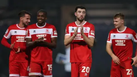 Finn Azaz claps his hands along with other Middlesbrough players after a match 