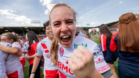 St Helens winger Dani McGifford roars happily into the camera with a fist punching the air in delight after a Challenge Cup semi-final win over York