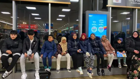 Family photo Community buying snacks for Iftar