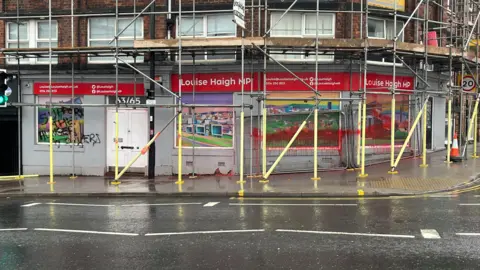 A photo of graffiti at Louise Haigh's constituency office in Sheffield. Some black graffiti reads 'Support the hunker strikers'. Red paint also appears to have been splashed over a window.