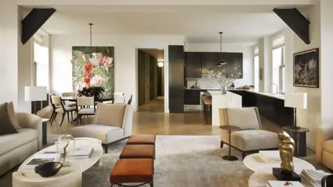 Adrian Gaut Open-concept apartment living room with modern furniture and kitchen