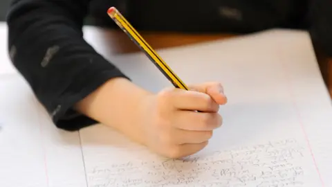 PA Media Child writing