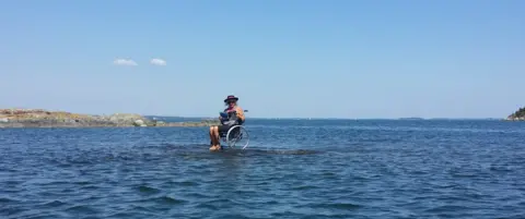 Erik Wellton Carina Wellton in her wheelchair on an islet