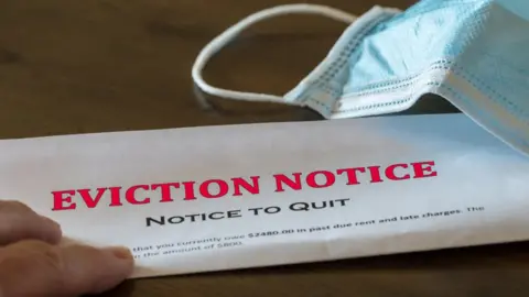 Getty Images Eviction notice and mask