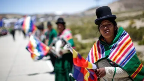 Reuters Supporters hold Whipala flags during Bolivia"s former President Evo Morales"s caravan between Uyuni and Oruro, upon his return to the country, in Uyuni, Bolivia November 10, 2020